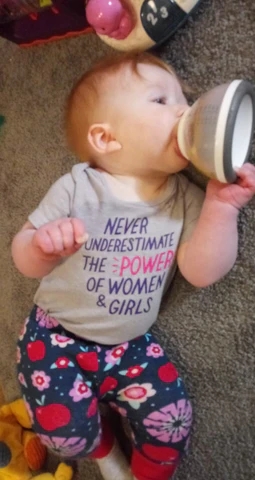 baby self feeding with breastmilk bottle