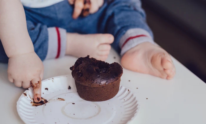 Baby eating chocolate cupcake