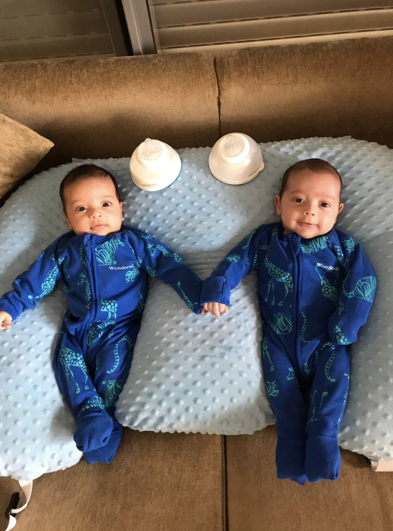 twin babies with breast milk bottles